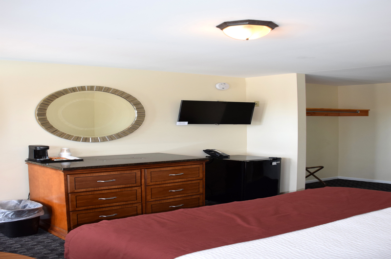 Poolside King room with Hanging Flatscreen TV, Fridge, and Coffee Maker