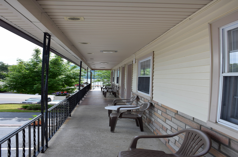 Shared Porch with tables and chairs outside rooms