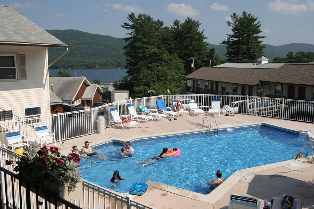 Guest swimming in pool overlooking lake